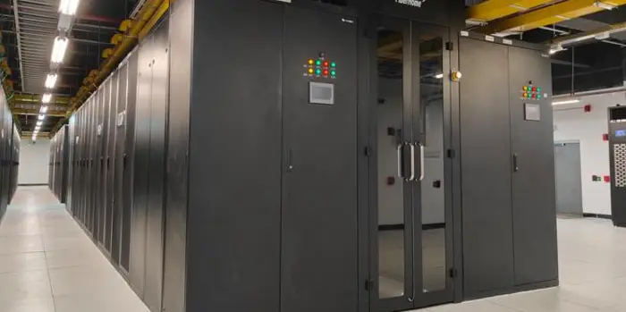 Modular immersion cooling system installed inside a semiconductor-grade cleanroom